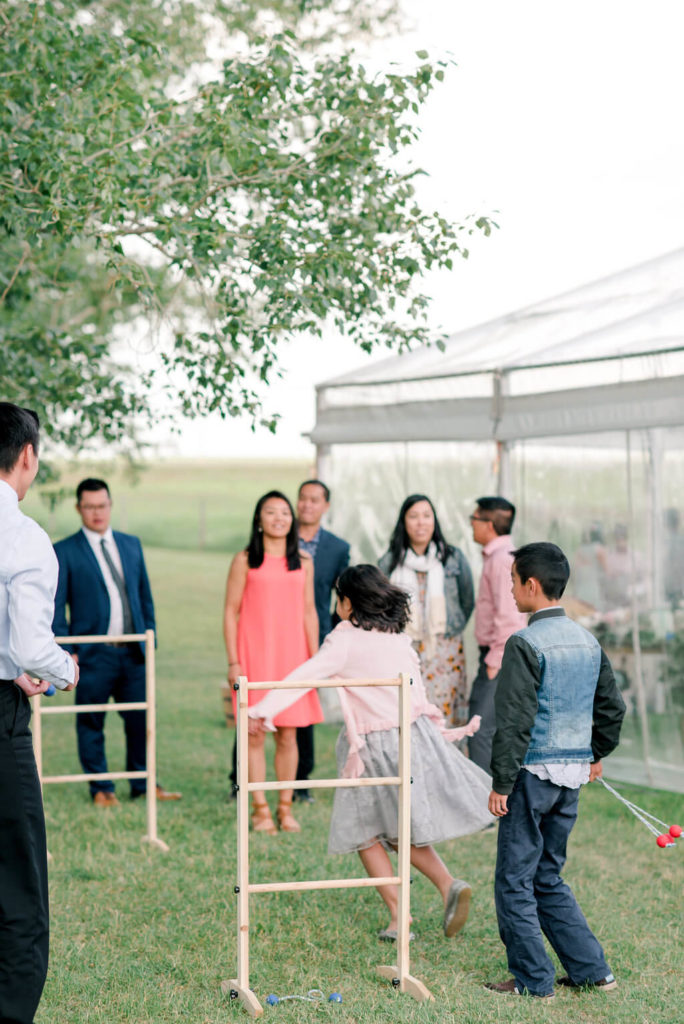 having games at an outdoor wedding is a great way to entertain guests. Fun backyard wedding! https://www.thegathered.ca