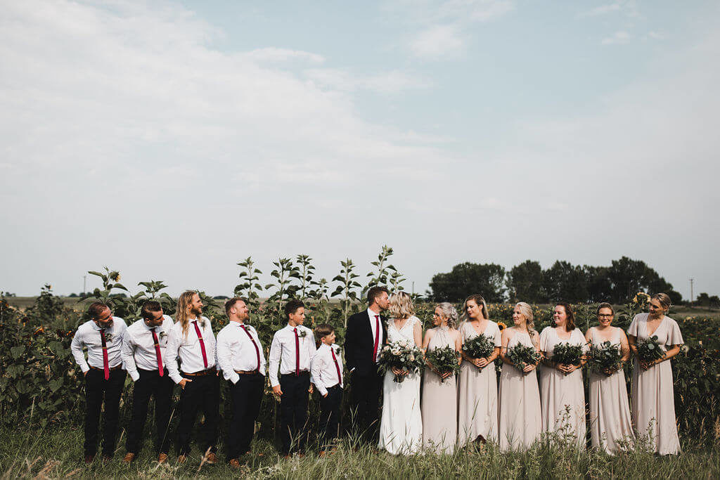 wedding party taking pictures in the garden of their prairie wedding https://www.thegathered.c